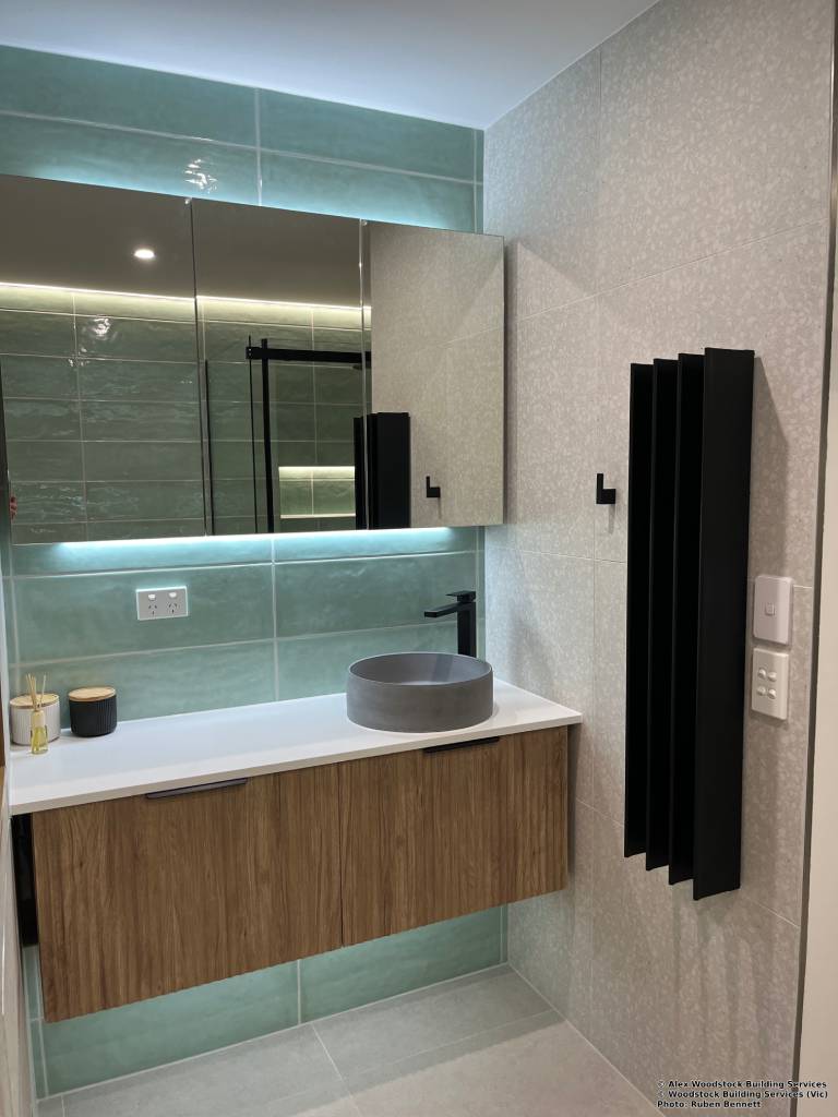 Complete bathroom laundry renovations Melbourne showing structural reconfiguration and modern tiling layouts